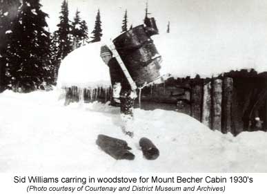 Sid Williams carring in a wood stove for Mount Becher Cabin 1930's